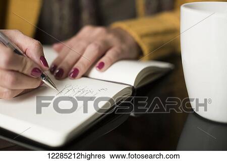 Woman writing thoughts in a journal; Toronto, Ontario, Canada View Large Photo Image Stock Photograph - Woman writing thoughts in a journal; Toronto, Ontario, Canada. Fotosearch