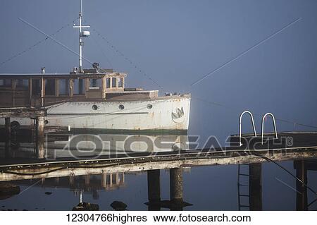 Stock Photograph - Wooden boat on foggy lake; Bellingham, Washington, United States of America. Fotosearch