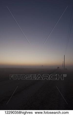 Stock Photograph - Woolwich Guelph townline before sunrise on a foggy morning; Mosborough, Ontario, Canada. Fotosearch
