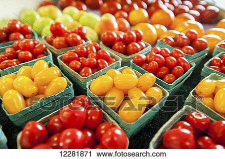 Stock Image - Yellow and red cherry tomatoes in containers; Denton, Maryland, United States of America. Fotosearch