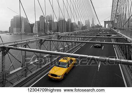 Stock Photograph - Yellow cab on Brooklyn bridge; Brooklyn, New York, United States of America. Fotosearch
