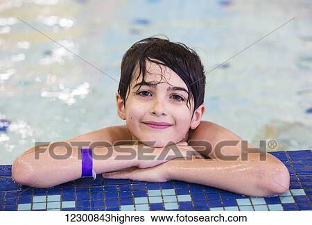 Young boy in an indoor swimming pool; Spruce Grove, Alberta, Canada View Large Photo Image Stock Photograph - Young boy in an indoor swimming pool; Spruce Grove, Alberta, Canada. Fotosearch