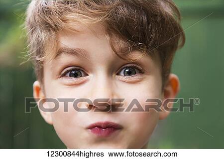 Stock Photograph - Young boy making a funny face for the camera; Edmonton, Alberta, Canada. Fotosearch