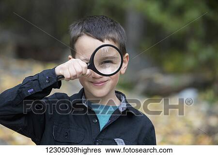 Young boy playing with a large magnifying glass, Palmer, Southcentral Alaska, autumn View Large Photo Image Stock Photograph - Young boy playing with a large magnifying glass, Palmer, Southcentral Alaska, autumn. Fotosearch