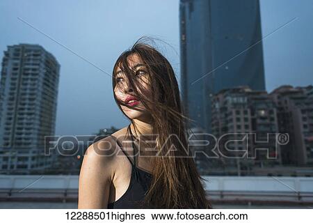 Young female Chinese model on a rooftop in evening, fresh and fashion feeling; Xiamen, Fujian, China View Large Photo Image Stock Photograph - Young female Chinese model on a rooftop in evening, fresh and fashion feeling; Xiamen, Fujian, China. Fotosearch