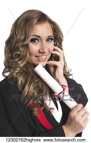 Young female graduate holding her diploma and talking on her smart phone; Edmonton, Alberta, Canada View Large Photo Image Stock Photograph - Young female graduate holding her diploma and talking on her smart phone; Edmonton, Alberta, Canada. Fotosearch