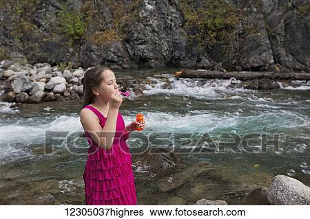 Young girl blowing bubbles along the Little Susitna river near Hatcher Pass, Southcentral Alaska, autumn View Large Photo Image Stock Photograph - Young girl blowing bubbles along the Little Susitna river near Hatcher Pass, Southcentral Alaska, autumn. Fotosearch