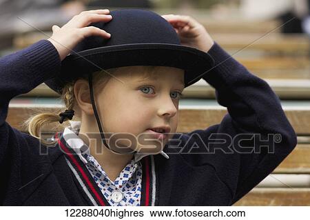 Young girl with her hands on her blue felt hat wearing school uniform; London, England View Large Photo Image Stock Photograph - Young girl with her hands on her blue felt hat wearing school uniform; London, England. Fotosearch
