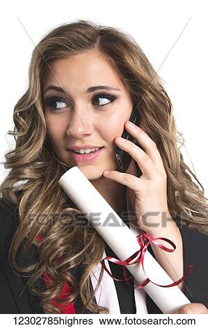 Young graduating woman holding her diploma and talking on her smart phone; Edmonton, Alberta, Canada View Large Photo Image Stock Photograph - Young graduating woman holding her diploma and talking on her smart phone; Edmonton, Alberta, Canada. Fotosearch