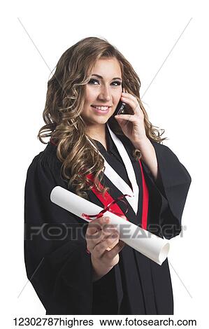 Young graduating woman holding her diploma and talking on her smart phone; Edmonton, Alberta, Canada View Large Photo Image Stock Photograph - Young graduating woman holding her diploma and talking on her smart phone; Edmonton, Alberta, Canada. Fotosearch