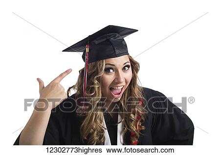 Young graduating woman pointing at her grad cap in celebration; Edmonton, Alberta, Canada View Large Photo Image Stock Photograph - Young graduating woman pointing at her grad cap in celebration; Edmonton, Alberta, Canada. Fotosearch