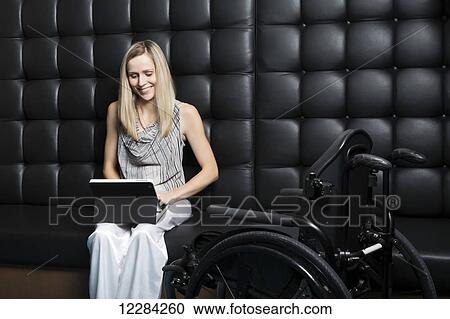 Young professional business woman who is a paraplegic working on her computer; St. Albert, Alberta, Canada View Large Photo Image Stock Image - Young professional business woman who is a paraplegic working on her computer; St. Albert, Alberta, Canada. Fotosearch
