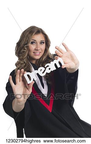 Stock Photograph - Young woman dreaming about her future now that she has graduated; Edmonton, Alberta, Canada. Fotosearch
