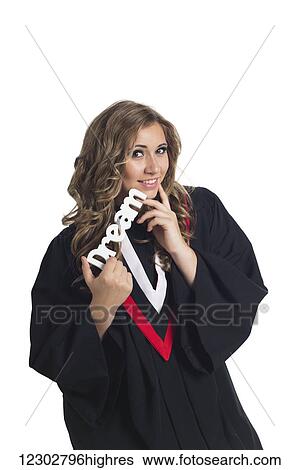 Stock Photograph - Young woman dreaming about her future now that she has graduated; Edmonton, Alberta, Canada. Fotosearch