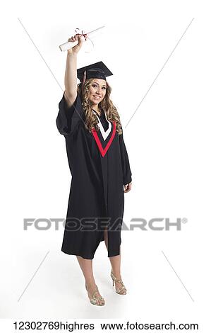 Young woman graduate holding her diploma up in celebration of her graduation; Edmonton, Alberta, Canada View Large Photo Image Stock Photograph - Young woman graduate holding her diploma up in celebration of her graduation; Edmonton, Alberta, Canada. Fotosearch