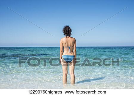 Young woman in a blue bikini at Mari Ermi beach, also known as the beach of the grains of rice; Oristano, Sardinia, Italy View Large Photo Image Stock Photograph - Young woman in a blue bikini at Mari Ermi beach, also known as the beach of the grains of rice; Oristano, Sardinia, Italy. Fotosearch
