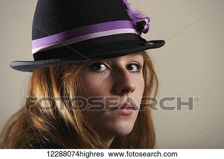 Young woman with red hair in a blue hat with ribbon looking serious; Caldecott, England View Large Photo Image Stock Photograph - Young woman with red hair in a blue hat with ribbon looking serious; Caldecott, England. Fotosearch