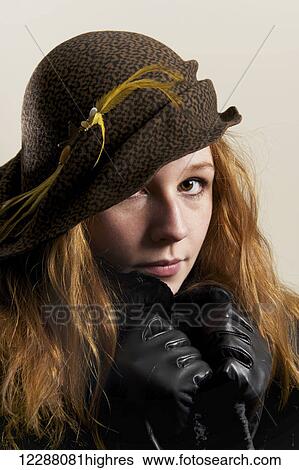 Young woman with red hair in a hat and black leather gloves; Caldecott, England View Large Photo Image Stock Photograph - Young woman with red hair in a hat and black leather gloves; Caldecott, England. Fotosearch
