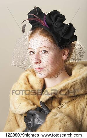 Young woman with red hair in a veiled black hat with feathers and fur coat; Caldecott, England View Large Photo Image Stock Photograph - Young woman with red hair in a veiled black hat with feathers and fur coat; Caldecott, England. Fotosearch