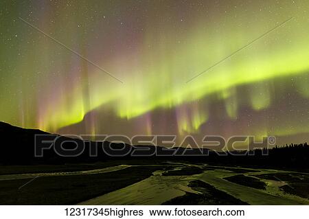 Stock Photograph - 0rthern Lights over Teklanika River and the Alaska Range in Denali National Park, Interior Alaska, USA. Fotosearch
