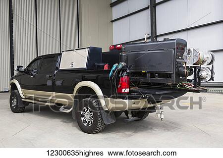 Stock Photograph - 3/4 ton pickup truck with welding equipment mounted on a rolling cargo bed; Edmonton, Alberta, Canada. Fotosearch