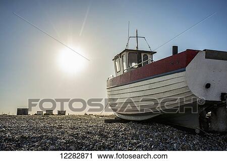 A boat on a shingle beach; Dungeness, Kent, England View Large Photo Image Stock Image - A boat on a shingle beach; Dungeness, Kent, England. Fotosearch