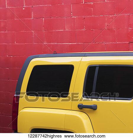 A bright yellow vehicle parked against a painted red wall; Vancouver, British Columbia, Canada View Large Photo Image Stock Photograph - A bright yellow vehicle parked against a painted red wall; Vancouver, British Columbia, Canada. Fotosearch
