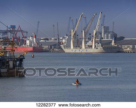A busy port with cranes and ships; Dar es Salaam, Tanzania View Large Photo Image Stock Photo - A busy port with cranes and ships; Dar es Salaam, Tanzania. Fotosearch