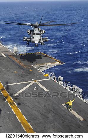 A CH-53 Sea Stallion helicopter comes in for a landing on the flight deck of the USS Peleliu (LHA-5) out in the Pacific Ocean; Hawaii, United States of America View Large Photo Image Stock Photograph - A CH-53 Sea Stallion helicopter comes in for a landing on the flight deck of the USS Peleliu (LHA-5) out in the Pacific Ocean; Hawaii, United States of America. Fotosearch