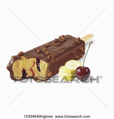 Stock Photograph - A chocolate covered ice cream treat with a cherry and banana slices on a white background; Toronto, Ontario, Canada. Fotosearch