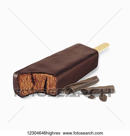 Stock Photograph - A chocolate covered ice cream treat filled with chocolate ice cream on a white background; Toronto, Ontario, Canada. Fotosearch