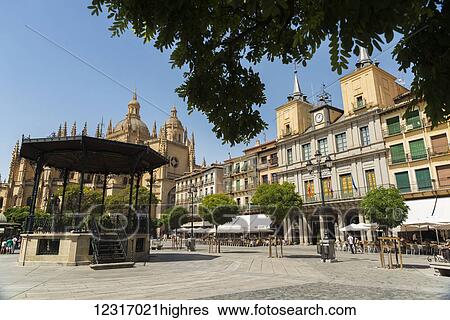 Stock Photograph - A church and buildings in a town square; Segovia, Castilla Leon, Spain. Fotosearch