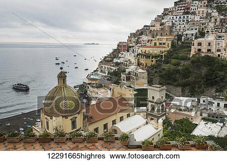 A church building and houses on a hillside with boats moored along the Amalfi coast; Positano, Campania, Italy View Large Photo Image Stock Photograph - A church building and houses on a hillside with boats moored along the Amalfi coast; Positano, Campania, Italy. Fotosearch