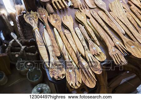 A collection of hand crafted wood salad serving sets is laid out on a table for sale in a tourist shop; Pisa, Siena, Italy View Large Photo Image Stock Photograph - A collection of hand crafted wood salad serving sets is laid out on a table for sale in a tourist shop; Pisa, Siena, Italy. Fotosearch