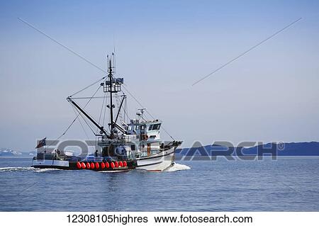 A commercial fishing boat on the waters of Main Bay, with the Chugach Mountains in the background, Prince William Sound, Whittier, Southcentral Alaska, USA View Large Photo Image Stock Photograph - A commercial fishing boat on the waters of Main Bay, with the Chugach Mountains in the background, Prince William Sound, Whittier, Southcentral Alaska, USA. Fotosearch