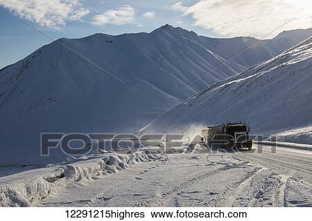 A commercial truck works its way up to Atigun Pass on the Dalton Highway in spring, Brooks Range, Arctic Alaska View Large Photo Image Stock Photograph - A commercial truck works its way up to Atigun Pass on the Dalton Highway in spring, Brooks Range, Arctic Alaska. Fotosearch