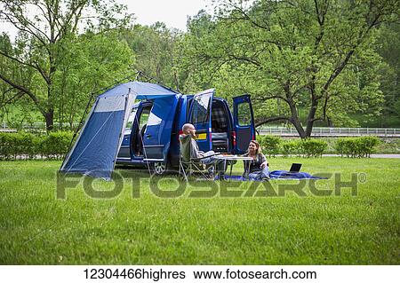 Stock Photograph - A couple camps just outside of the town centre of Cesky Krumlov, a beautiful little medieval city in the South Bohemian region; Czech Republic. Fotosearch