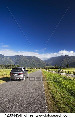 Stock Photograph - A drive through scenic West Coast farmland; Harihari, West Coast, New Zealand. Fotosearch