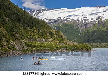 A family enjoying water sports on Portage Lake in Portage Valley, Summer, Alaska, USA. View Large Photo Image Stock Photograph - A family enjoying water sports on Portage Lake in Portage Valley, Summer, Alaska, USA.. Fotosearch