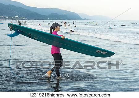A female surfer carries her longboard into the sea, Waiao beach, Yilan County; Yilan, Taiwan, China View Large Photo Image Stock Photograph - A female surfer carries her longboard into the sea, Waiao beach, Yilan County; Yilan, Taiwan, China. Fotosearch