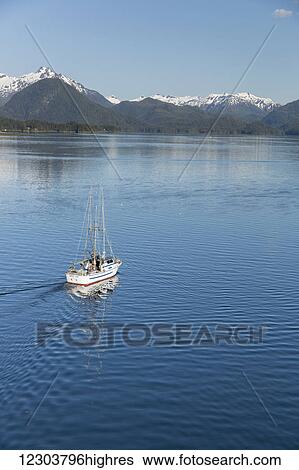 Stock Photograph - A fishing boat departs from the Sitka harbor into the Sitka Sound, Sitka, Southeast Alaska, USA, Summer. Fotosearch