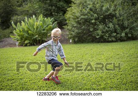 A five-year-old boy runs through a grassy field at JC Raulston Arboretum; Raleigh, North Carolina, USA View Large Photo Image Stock Photograph - A five-year-old boy runs through a grassy field at JC Raulston Arboretum; Raleigh, North Carolina, USA. Fotosearch