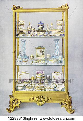 Stock Photograph - A glass case containing eighteenth century objects of art decorated in enamel. From The Queen The Lady's Newspaper published 1935.. Fotosearch