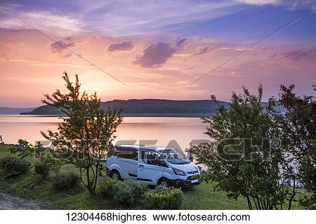 Stock Photograph - A group of travelers set up camp alongside of Lake Balton for the day; Zamardi, Somogy County, Hungary. Fotosearch