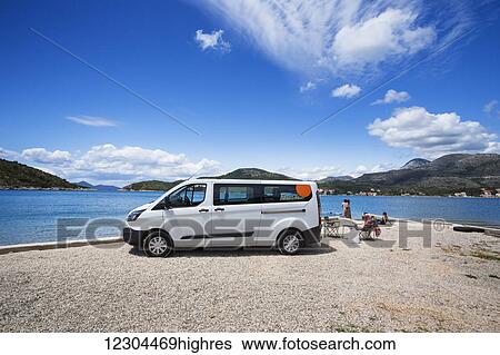 Stock Photograph - A group stops for an afternoon at the beach; Slano, Croatia. Fotosearch