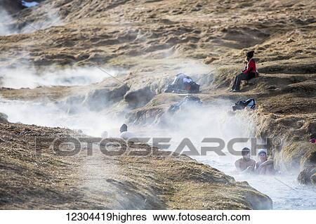 Stock Photograph - A hike through the Reykjadalur valley through thermal steam vents and boiling hot pools suitable for bathing; Reykjadalur valley, Reykjadalur, Iceland. Fotosearch