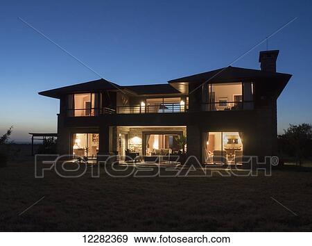 Stock Photo - A house illuminated at dusk, Ol Pejeda Conservancy; Kenya. Fotosearch