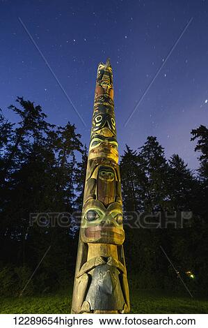 A large Totem Pole lit up at night in Sitka National Historic Park with star trails overhead, Sitka, Southeast Alaska, USA, Summer View Large Photo Image Stock Photograph - A large Totem Pole lit up at night in Sitka National Historic Park with star trails overhead, Sitka, Southeast Alaska, USA, Summer. Fotosearch