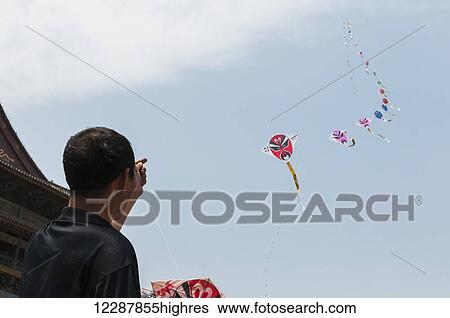 A Man Flying Traditional Chinese Kites; Xian, Shaanxi Province, China View Large Photo Image Stock Photograph - A Man Flying Traditional Chinese Kites; Xian, Shaanxi Province, China. Fotosearch