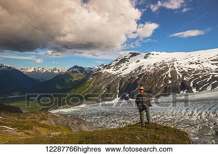 Stock Photograph - A man hiking near the Harding Ice Field Trail in Kenai Fjords National Park on the Kenai Peninsula in South Central Alaska. Fotosearch